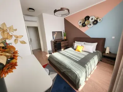 a bedroom with a bed with a green comforter at BW Aqua LUX, river view, parking free in Belgrade