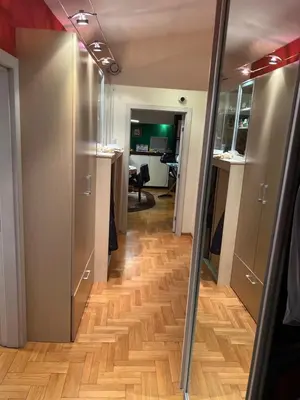 a hallway with wood floors in a room at Za studente 15 marta in Belgrade