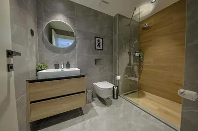 a bathroom with a toilet and a sink and a shower at ZIGZAG Belgrade Waterfront - SIMFONIJA 2 in Belgrade