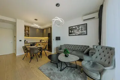 a living room with a couch and chairs and a table at ZIGZAG Belgrade Waterfront - SIMFONIJA 2 in Belgrade