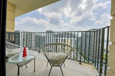 a balcony with a table and chairs and a view of a city at ZIGZAG Belgrade Waterfront - SIMFONIJA 2 in Belgrade
