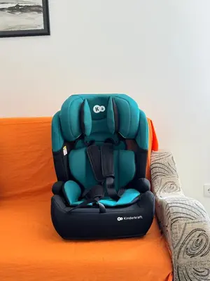 a baby car seat sitting on top of a bed at Belgrade Airport Beds in Surčin