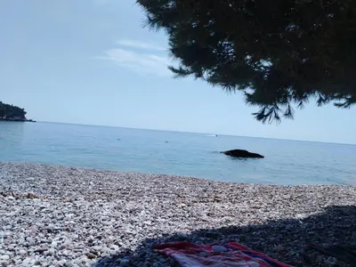 a rocky beach with a large object in the water at Drago Sutomore 2025 in Borča
