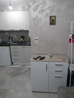a kitchen with white cabinets and a white refrigerator at Drago Sutomore 2025 in Borča