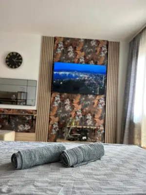 a rolled up towel sitting on top of a bed at Mama in Belgrade