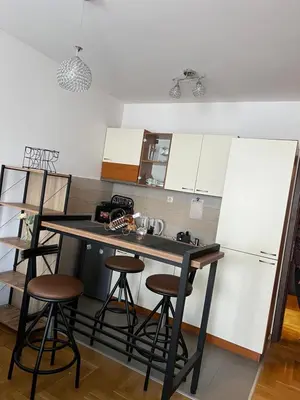 a kitchen with a counter and stools in it at Mama in Belgrade
