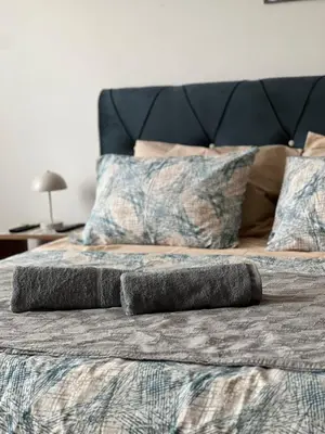 a bed with two pillows on top of it at Mama in Belgrade