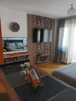 a living room with a bed and a large clock at Mama in Belgrade