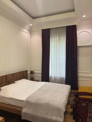 a bedroom with a bed and a window at Apartman V Dedinje in Belgrade