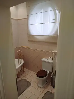 a bathroom with a toilet and a tub and a sink at Apartman V Dedinje in Belgrade