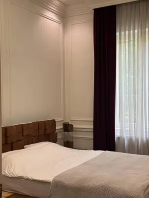 a bedroom with a bed and a window at Apartman V Dedinje in Belgrade