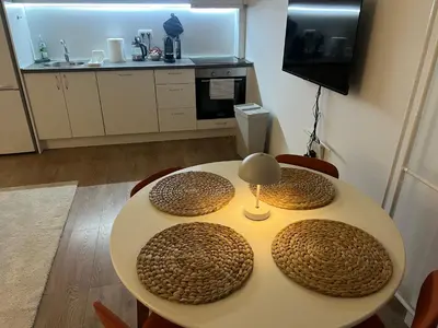 a table with two stools and a table with at Sassy in Belgrade