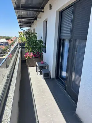 a balcony with a bench on a building at Apartman Idila in Ruma