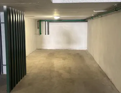 an empty room with a white wall and a door at Apartman Idila in Ruma