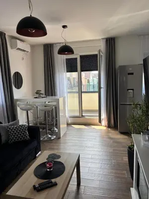 a living room with a couch and a table at Apartman Idila in Ruma