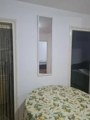 a bedroom with a bed and a mirror on the wall at Masha in Belgrade
