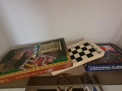 two board games and a chess board on a shelf at Masha in Belgrade