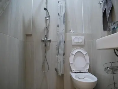 a small bathroom with a toilet and a shower at Terazije apartment in Belgrade