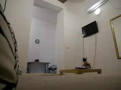a white room with a television and a table at Terazije apartment in Belgrade