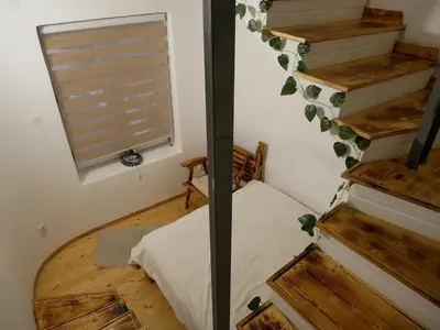 a room with a bed and stairs with a window at Terazije apartment in Belgrade