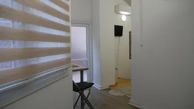 a room with a chair and a table and a window at Terazije apartment in Belgrade