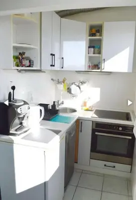 a white kitchen with a sink and a stove at Vesna apartment in Belgrade