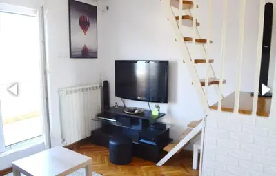 a living room with a flat screen tv on a wall at Vesna apartment in Belgrade