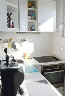 a white kitchen with a sink and a stove at Vesna apartment in Belgrade