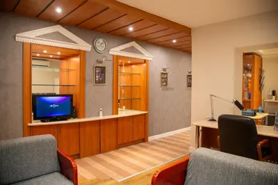 a waiting room with a tv and two chairs at Apartment F14 in Belgrade