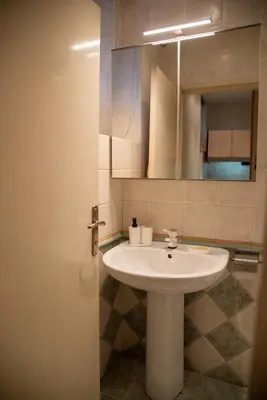 a bathroom with a white sink and a mirror at Apartment F14 in Belgrade