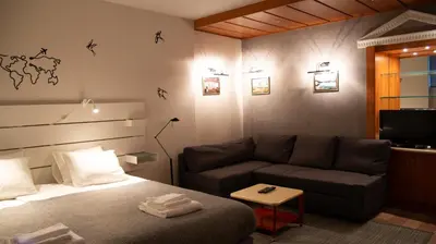 a bedroom with a bed and a couch at Apartment F14 in Belgrade