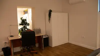 an office with a desk and a chair and a mirror at Apartment F14 in Belgrade