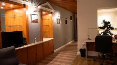 a hallway with a desk and a tv and a room at Apartment F14 in Belgrade