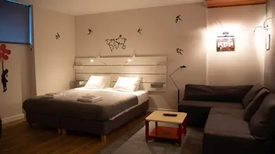 a small bedroom with a bed and a couch at Apartment F14 in Belgrade
