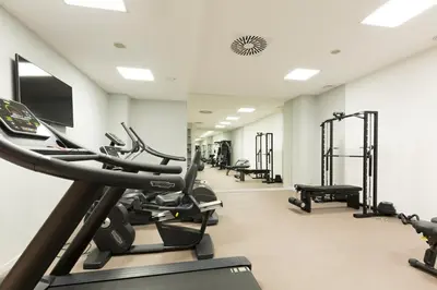 a gym with treadmills and elliptical machines at Envoy Hotel in Belgrade