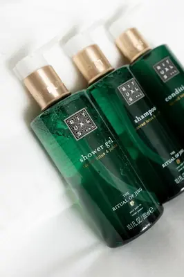 two green bottles of soap sitting next to each other at Envoy Hotel in Belgrade