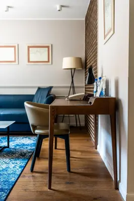 a desk in a living room with a chair at Envoy Hotel in Belgrade