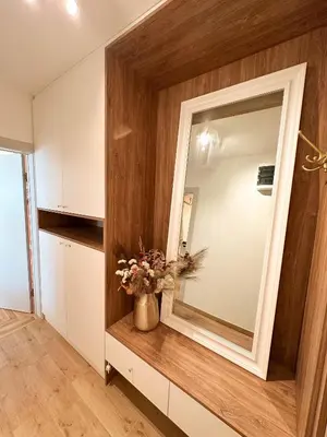a bathroom with a mirror and a vase of flowers at Marasca Belgrade - Cozy, Chic & Nomad-friendly Flat in Downtown in Belgrade