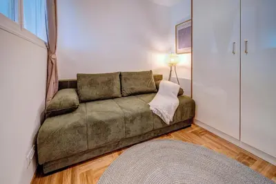 a living room with a couch in a room at Marasca Belgrade - Cozy, Chic & Nomad-friendly Flat in Downtown in Belgrade