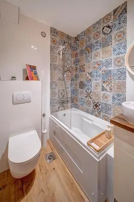 a bathroom with a tub and a toilet and a sink at Marasca Belgrade - Cozy, Chic & Nomad-friendly Flat in Downtown in Belgrade