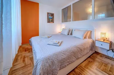 a bedroom with a large bed with white sheets at Marasca Belgrade - Cozy, Chic & Nomad-friendly Flat in Downtown in Belgrade
