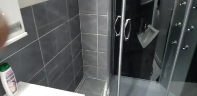 a shower with a glass door in a bathroom at melvina 2 in Pančevo