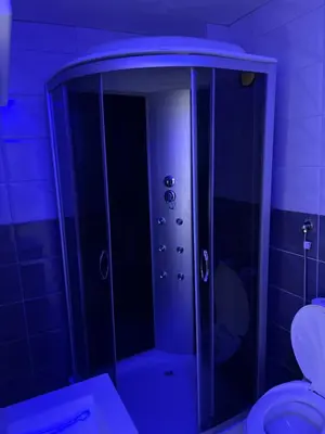 a shower with a glass door in a bathroom at melvina 2 in Pančevo