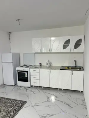 a white kitchen with white cabinets and appliances at melvina 2 in Pančevo