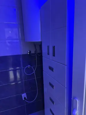 a bathroom with a blue light next to a cabinet at melvina 2 in Pančevo