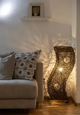 a lamp sitting next to a couch in a living room at Emi Quiet & Cozy Stay in Belgrade