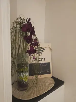 a vase with flowers in it on a table at Apartment Eleon in Belgrade