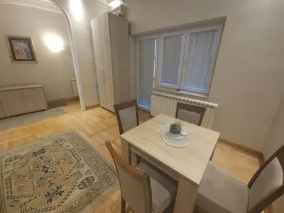 a dining room with a table and chairs at Apartment Eleon in Belgrade