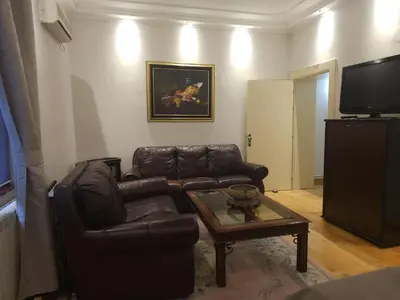a living room with a couch and a coffee table at Apartment Eleon in Belgrade
