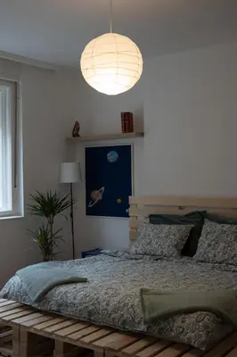 a bedroom with a large bed and a lamp at Belgrade Urban Central Flat in Belgrade